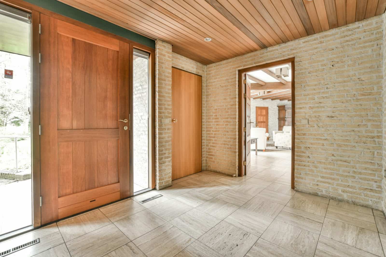 The facade of a brick building with wooden door